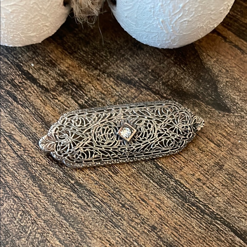 Intricate Silver Brooch with Diamond Accent
